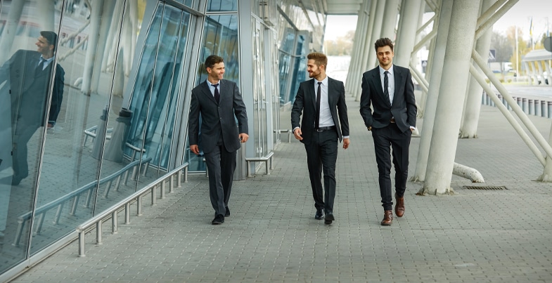 3-men-in-suits-walking-outside-of-office-building-F